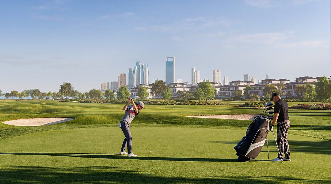 Golfers on the course with the Abu Dhabi skyline behind
