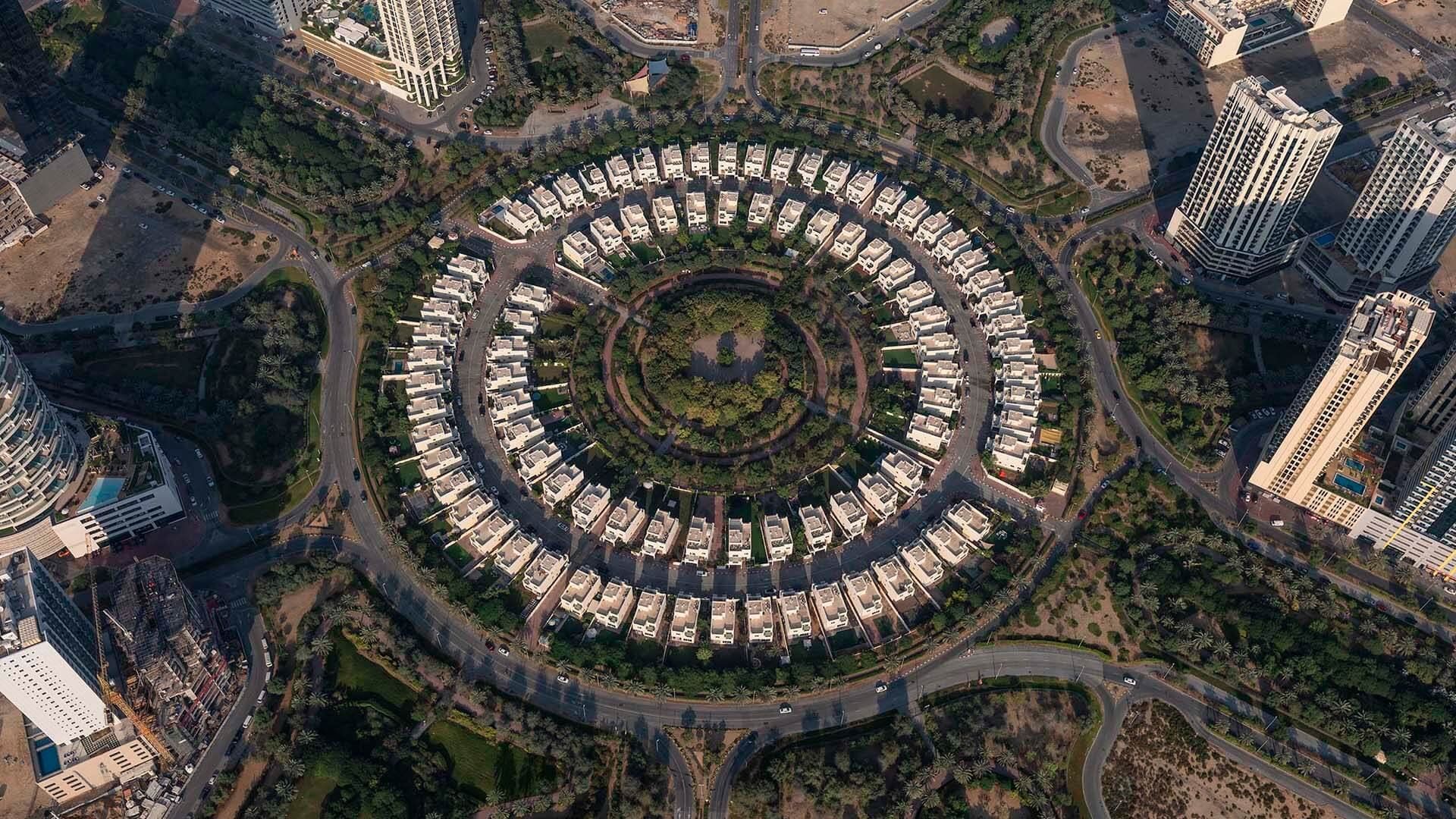 A circle of villas seen from above